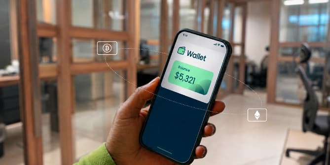 A hand holding a phone showing a crypto wallet balance in an office